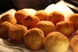 Sicilian ricotta arancini served on a decorated ceramic plate