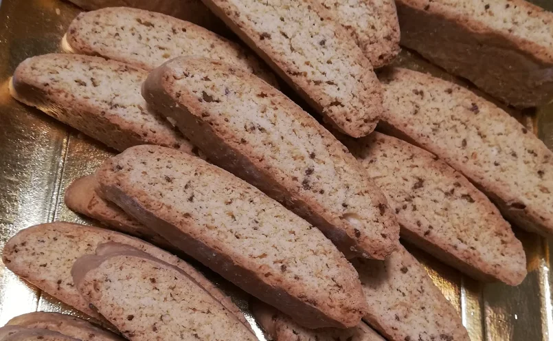 Golden, fragrant Sicilian anise biscuits arranged on a ceramic plate